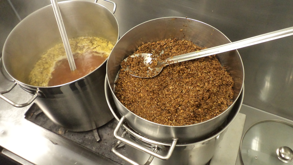 Straining specialty grains into the kettle.